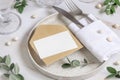 Elegant Table setting with a card decorated with eucalyptus branches close up, Wedding mockup Royalty Free Stock Photo