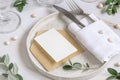 Elegant Table setting with a card decorated with eucalyptus branches close up, Wedding mockup Royalty Free Stock Photo