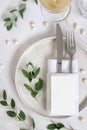 Elegant Table setting with a card decorated with eucalyptus branches top view, Wedding mockup Royalty Free Stock Photo