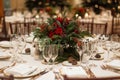 Elegant table setting for Christmas with greenery and pine cones as decorations, Elegant table settings with holiday themed