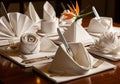 An elegant table setting features intricately folded white napkins Royalty Free Stock Photo