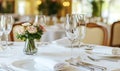 Elegant table setting with flowers in a restaurant banquet hall, ready for a celebration Royalty Free Stock Photo