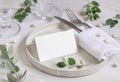 Table setting with folded card decorated with eucalyptus branches close up, Wedding mockup Royalty Free Stock Photo