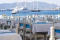 Elegant table setting with fork, knife, wine glass, white plate and blue napkin in restaurant. Turkey. Beach cafe near sea Royalty Free Stock Photo