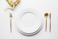 Elegant table setting with golden cutlery on white background. Top view Royalty Free Stock Photo