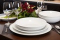 Elegant table setting with modern plates, glasses, and crockery in a contemporary kitchen Royalty Free Stock Photo