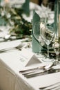 Elegant table setting at the restaurant. Wedding banquet with floral decoration on table, cards