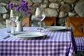 Elegant table setting with stone wall background Royalty Free Stock Photo