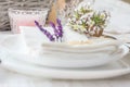 Elegant table setting for wedding engagement Easter dinner with white ceramic plates cotton napkin tied with twine lavender flower Royalty Free Stock Photo