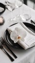 Elegant table setting with white orchids and black plate for formal dining Royalty Free Stock Photo