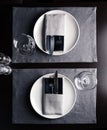 Elegant table setting white plates on black wooden table Royalty Free Stock Photo