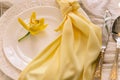 Elegant table setting with yellow orchid and gold flatware Royalty Free Stock Photo