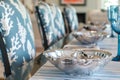 elegant table with silver shell bowls, coralprint chair covers, and blue stemware Royalty Free Stock Photo