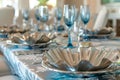 elegant table with silver shell bowls, coralprint chair covers, and blue stemware Royalty Free Stock Photo