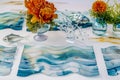 elegant table with watercolor wave placemats, glass fish sculptures, and a seaweedinspired centerpiece
