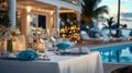 Elegant tables arranged for a poolside dinner at a luxurious resort. Royalty Free Stock Photo
