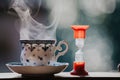 Elegant tea cup and hourglass stand shelf Royalty Free Stock Photo