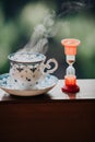 Elegant tea cup and hourglass stand shelf Royalty Free Stock Photo