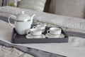 Elegant tea cup set on black tray in modern bedroom Royalty Free Stock Photo