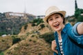 Elegant tourist smiling lovely and taking selfie