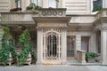 elegant townhouse entrance with ornate wrought iron grill on door