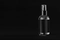 Elegant transparent spray dispenser bottle for cosmetics with black label on black background, mock up for branding, design.