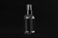 Elegant transparent spray dispenser bottle for cosmetics with black label on dark black background, mock up for branding, design.