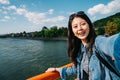 Elegant traveler taking selfie with clean river