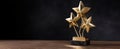 The elegant trophy featuring three golden stars on a dark background..AI generated image Royalty Free Stock Photo