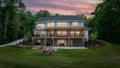 Elegant Two-Story Home at Dusk with Nature View. Concept Home Exterior, Dusk Photography, Elegant Royalty Free Stock Photo