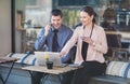 Elegant two young business people having an informal coffee meeting - Happy couple sitting on a cafe terrace flirting Royalty Free Stock Photo