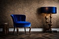An elegant velvet-covered chair in royal blue, placed against a textured taupe wall, bathed in warm ambient lighting