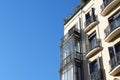 Elegant vintage balconies glazed and open on the corner of antique building downtown Madrid, Spain Royalty Free Stock Photo