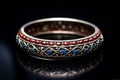 Elegant vintage bangle with intricate designs on a reflective surface