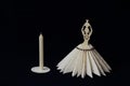 Elegant vintage stylized napkin stand and wax candle on white lace napkin on black background. Minimal style. Concept - serving, Royalty Free Stock Photo