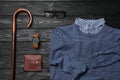 Elegant walking cane, sweater and men`s accessories on black wooden table, flat lay Royalty Free Stock Photo