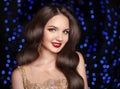 Elegant wavy hairstyle. Beautiful brunette smiling with long retro hair, red lips makeup and fashion jewelry earrings isolated on