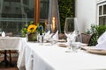 Elegant wedding lunch table decorated with crystal goblets and yellow flowers. Royalty Free Stock Photo