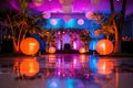 Elegant wedding reception area with round tables, palm trees, and lighting Royalty Free Stock Photo