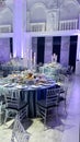 Elegant wedding reception hall with round tables and crystal chandeliers Royalty Free Stock Photo