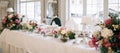 Elegant wedding reception white table arrangement, floral centerpiece decoration, restaurant Royalty Free Stock Photo