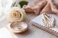 Elegant Wedding Ring, Rose, and Pearls Composition on Wood Royalty Free Stock Photo
