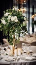 Elegant wedding table decoration with many candles and flowers, predominantly white color