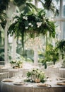 Elegant wedding table decoration with many candles and flowers, predominantly white color