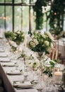 Elegant wedding table decoration with many candles and flowers, predominantly white color