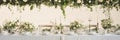 Elegant wedding table decoration with many candles and flowers, predominantly white color