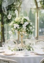 Elegant wedding table decoration with many candles and flowers, predominantly white color