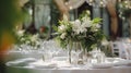 Elegant wedding table decoration with many candles and flowers, predominantly white color