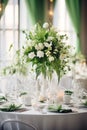 Elegant wedding table decoration with many candles and flowers, predominantly white color