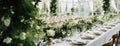 Elegant wedding table decoration with many candles and flowers, predominantly white color